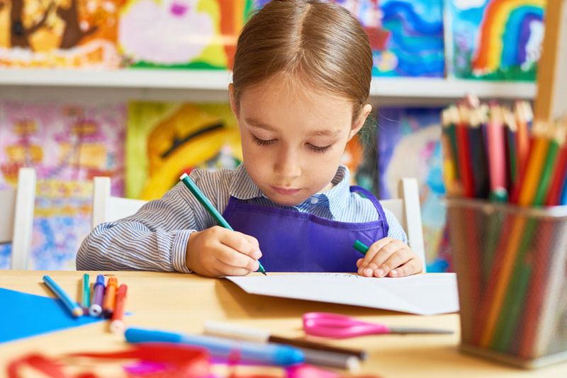 little-girl-drawing-in-pre-school-HQEMYWC-1.jpg